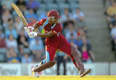 West Indies' Johnson Charles prepares to drive the ball against the Prime Minister's XI during their one-day cricket match in Canberra, Australia, Tuesday, Jan. 29, 2013.