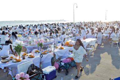 Partygoers at a chic all white dinner party. Sephron Mair/The Signature Society