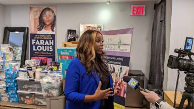 Council Member Farah Louis addresses the media after distributing winter coats to asylum seekers in East Flatbush.