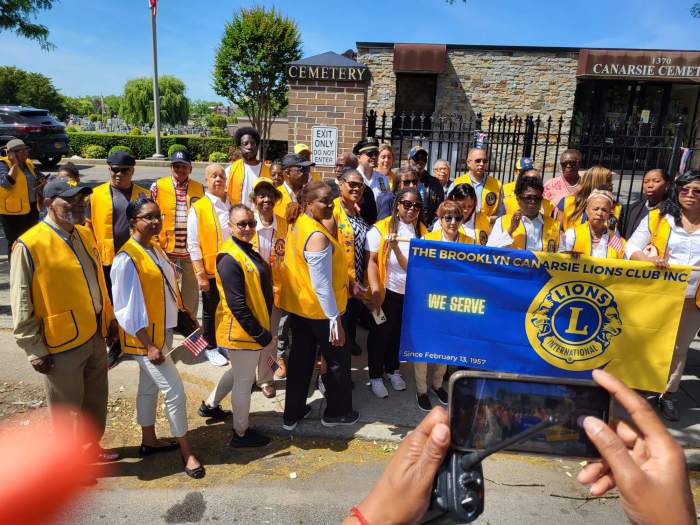 President Dr. Jean Joseph, third from right, front row, with fellow Lions and elected officials at the Canarsie Cemetery for the laying of a wreath to honor America's fallen heroes.