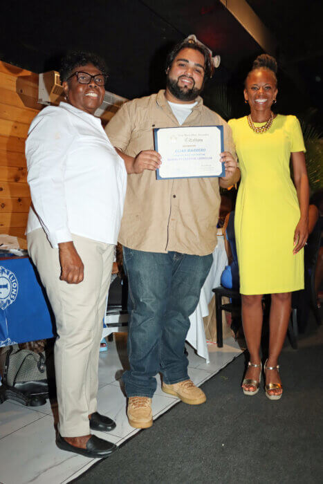 Councilmember Monique Chandler-Waterman, right, presents certificates new inductee Elias Morrero, flanked by Brooklyn Canarsie Lions President Jean Joseph.