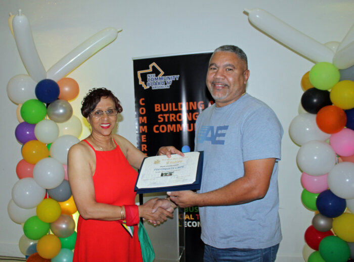 Community Board 17 Commerce Committee Chairperson June Persaud presented Robert Gordon, president & Ceo Footprints Cafe- home of the Rasta pasta with a Citation from the office of Assemblywoman Monique Chandler-Waterman, at a June 27 Caribbean Heritage celebration at J-Loft.