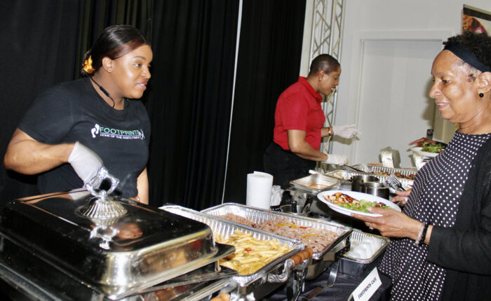 Celebrants enjoyed delicious jerk chicken, escovitch fish, peas and rice from Footprints Cafe, at a Caribbean Heritage Month Wine & Food presentation on June 27, hosted by Community Board 17 Commerce Committee.