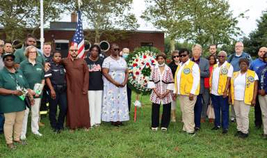 Jean Joseph, president of Brooklyn Canarsie Lions Club, eighth from left, with Lions vest, among celebrants at the 9/11 commemoration at Canarsie Park.