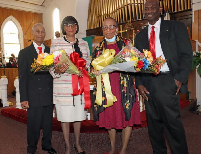 Min. Cynthia Grant, third from left, gives bouquet of flowers to Annette Whitehurst, wife of the Rev. Dr. Wilbur A. Whitehurst, Jr., flanked by Bros. Norman Edwards, left, and Alistair Aird.