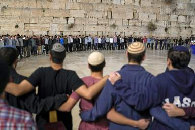 People attend a ceremony to mark the one-month anniversary of the bloody Oct. 7 cross-border attack by Hamas militants, in which 1,400 people were killed and 240 people kidnapped, mostly Israeli citizens, in front of the Western Wall, the holiest site where Jews can pray, in Jerusalem's Old City, Tuesday, Nov. 7, 2023. The cross-border attack by Hamas triggered a war that has raged for the past month.