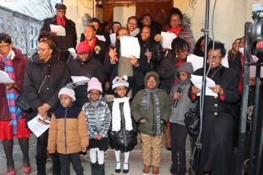 Sunday School children join adults in serenading on steps of Fenimore Street United Methodist Church.