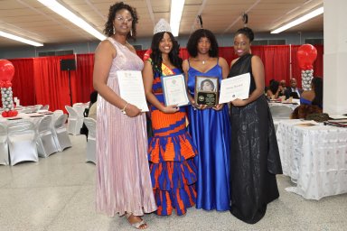 Donna Mitchell, second from right, receives award, from left, Jennifer Vechweg-Horsford, Miss Grenada USA Mickalia Forrester-Ewen and Ketura Brizan.