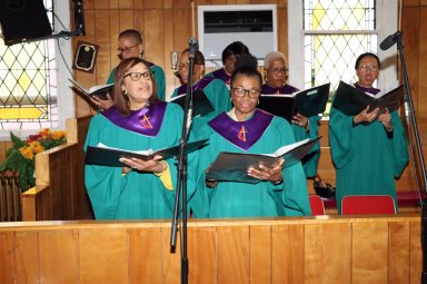 Chancel Choir leads congregation is singing "We Shall Overcome.”