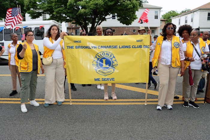 Brooklyn Canarsie Lions Club members with banner along parade route.