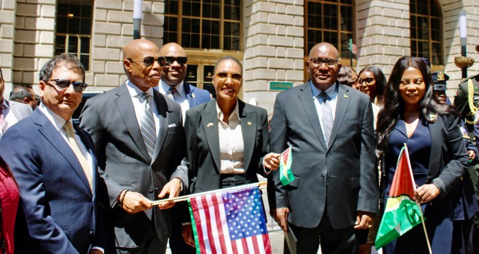 A colorful celebration honored Guyana's 58th Independence Anniversary at Bowling Green in New York City. Officials from left are Fazal Yussuff, advisor on Diaspora Affairs, Mayor Eric Adams, back row, Matthew Fraser NYC chief technology officer, NYPD First Deputy Commissioner Tania Kinsella, Consul General Michael E. Brotherson, and Consul General of Jamaica to New York Alsion Roach Wilson.