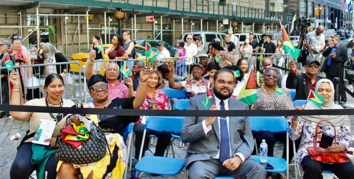 Nationals waved flags during Guyana's 58th Independence Anniversary at Bowling Green Square in NYC.