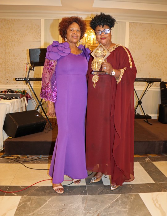 Evangelist Blucher, right, receives award from Judith Cuffy-Murray.