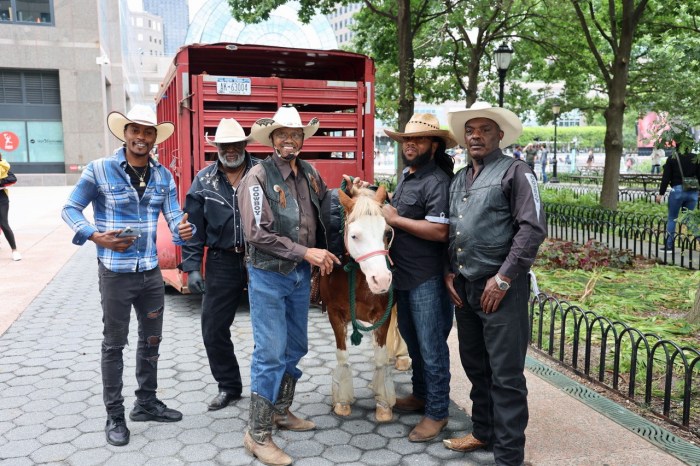 Members of The Federation of Black Cowboys pose with their steed.