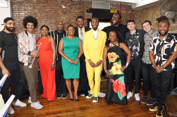 Brandon Bain, center, in yellow suit, with SVG Consul General Rondy "Luta" McIntosh, with tie, and his wife Semone, fourth from left, and members of the Sunlyte Band and VINCI.