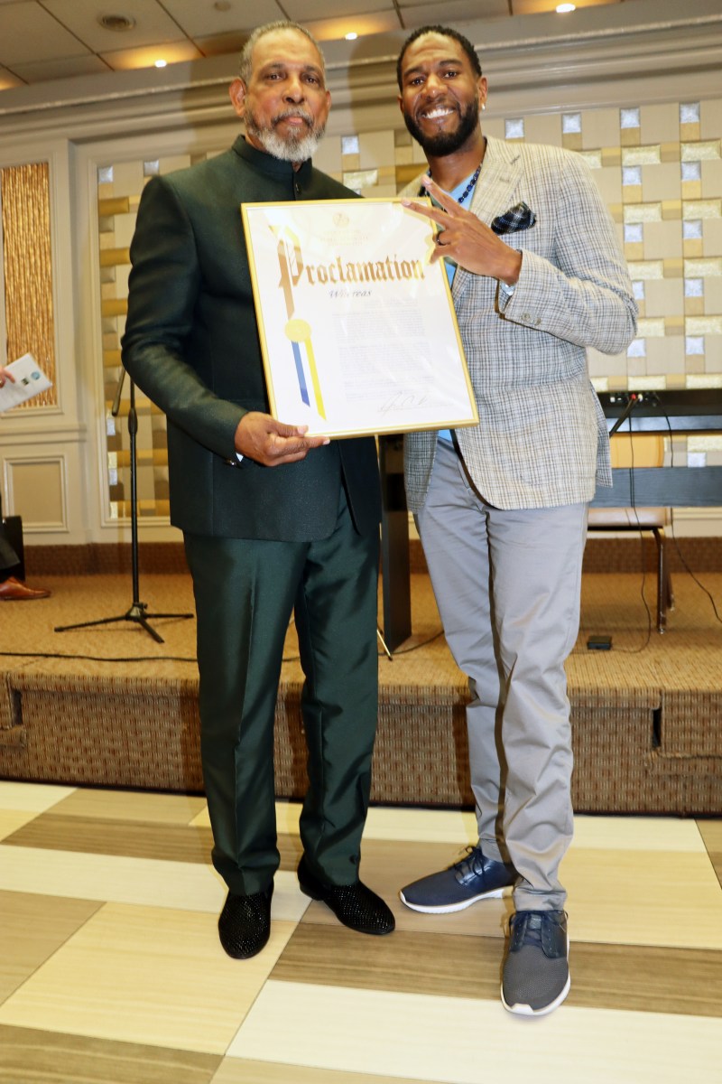 Public Advocate Jumaane Williams, right, presents proclamation to Eugene Pursoo.