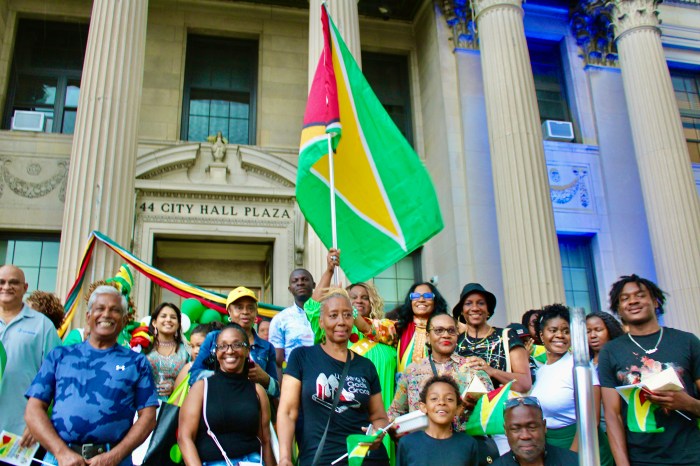 Compatriots join Lady Ira Lewis (center with flag) on East Orange NJ City Hall stairs to commemorate Guyana 58th Independence Anniversary on June 14.