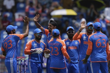 Players of India celebrate the dismissal of Australia's David Warner during an ICC T20 World Cup cricket match at Darren Sammy National Cricket Stadium in Gros Islet, St. Lucia on Monday, June 24, 2024.