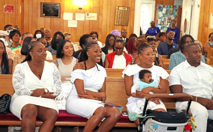A section of congregation, with parents of child, Sheldon Carty, Jr., in front pew, at right, to be baptized, with other relatives and friends.