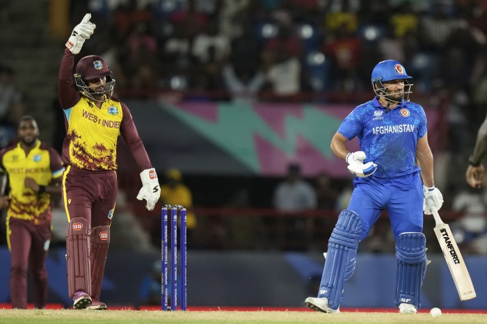 West Indies’ wicket keeper Nicholas Pooran celebrates the dismissal of Afghanistan’s Gulbadin Raib, right, during an ICC Men’s T20 World Cup cricket match at the Darren Sammy National Cricket Stadium in Gros Islet, St. Lucia, Monday, June 17, 2024.