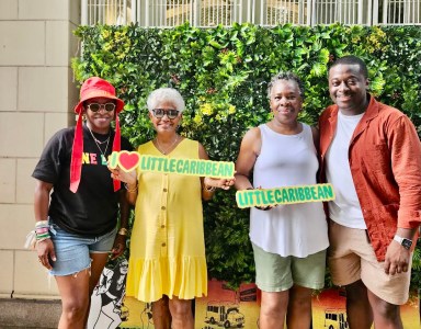 Founder and CEO of I Am Caribbeing, Shelley Worrell, mother, Marva Samaroo, with Charmaine and Jelanie Deshong holding the logo sign at the first One Love Little Caribbean Festival, at Prospect Park Boathouse, on June 23, 2024.