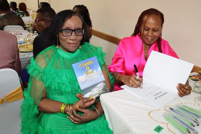 Dr. Nicholette "Koko" Spring, right, signs book for Venda Smith-Cyrus.
