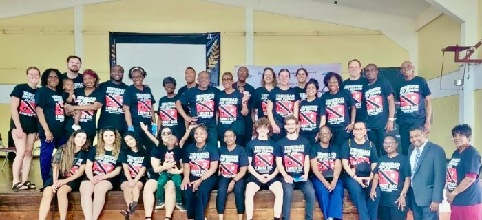 The team of doctors and health professionals wearing Trinidad & Tobago teeshirts, after providing dedicated services to outpatients during a medical mission hosted by Trinbago Progressive Association Inc. & APC Community Services, USA. Eleven from left, (front-row) is Guyanese American, Dr. Janice Emanuel, president, CEO of APC Community Services.
