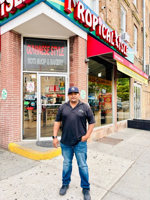 Danny Persaud, part owner of Tropical Isle Roti Shop, stands in front of his restaurant on Liberty Ave & Lefferts Blvd.