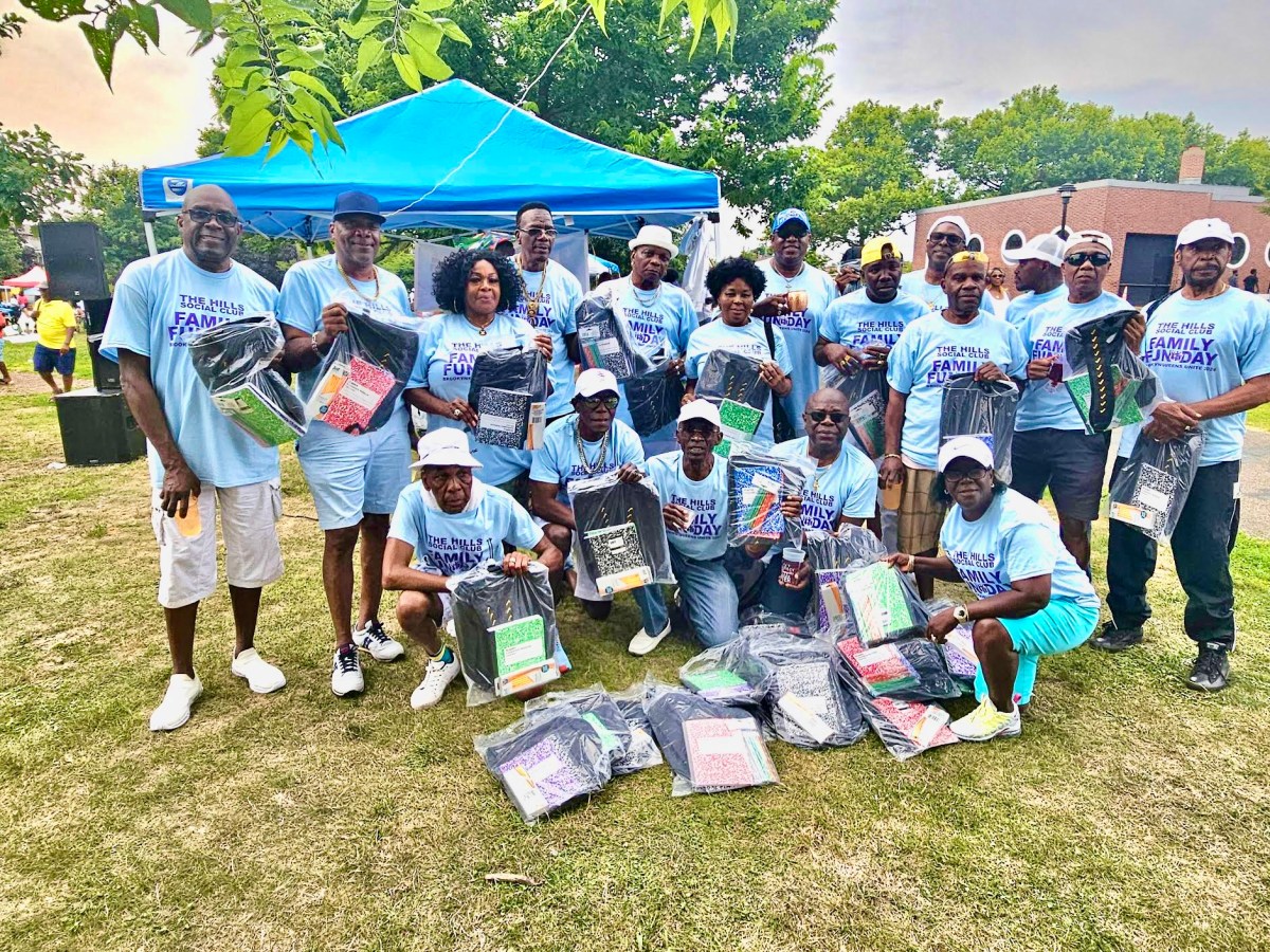 Third from left back row is Doris Rodney, founder, and members of the Hills Social Club, holding school supplies donated to students during the very first Brooklyn/Queens Linkup Family day on July 28, in Canarsie Park on Seaview Avenue