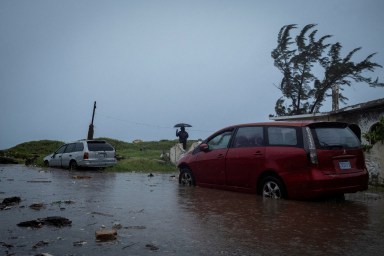 A man looks at breaking waves in the Caribbean Terrace neighborhood as Hurricane Beryl approaches, in Kingston, Jamaica, July 3, 2024.