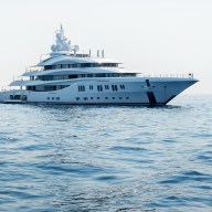 A large luxury private motor yacht under way sailing on the sea