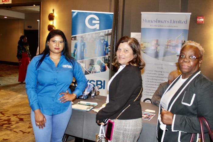 Public Relations officer of GYSBI Guyana, Gomatie Gangadin, with nationals at her table during the first Guyana Diaspora Job fair in the United States, at the Laguardia Airport Marriott.