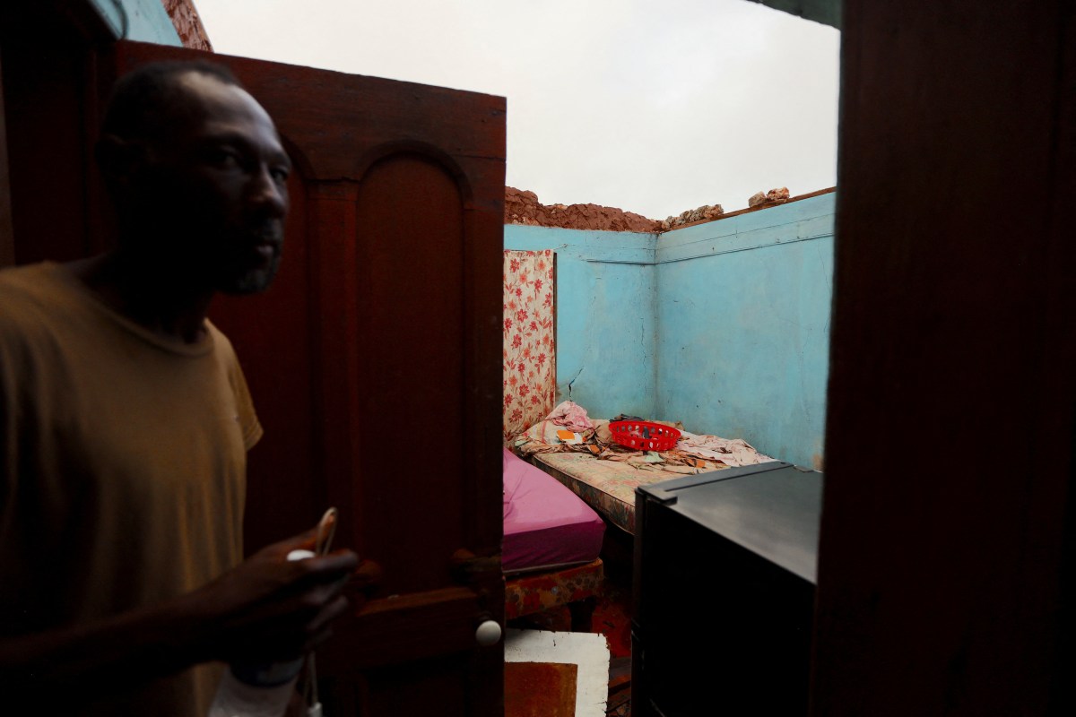 Collins Stephenson stands inside his home where the roof was ripped apart, in the aftermath of Hurricane Beryl, in St. Elizabeth Parish, Jamaica, July 5, 2024.