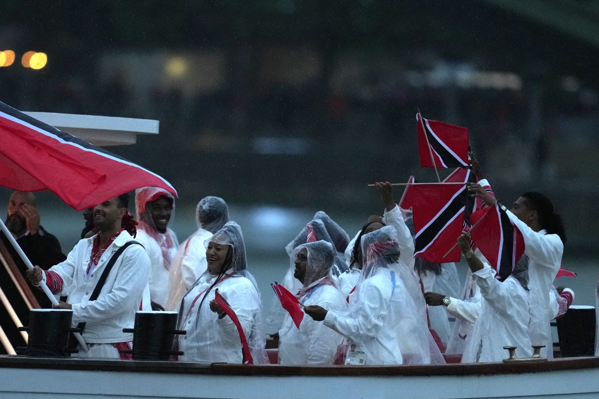 Paris 2024 Olympics - Opening Ceremony - Paris, France - July 26, 2024. Athletes of Trinidad & Tobago aboard a boat in the floating parade on the river Seine during the opening ceremony.