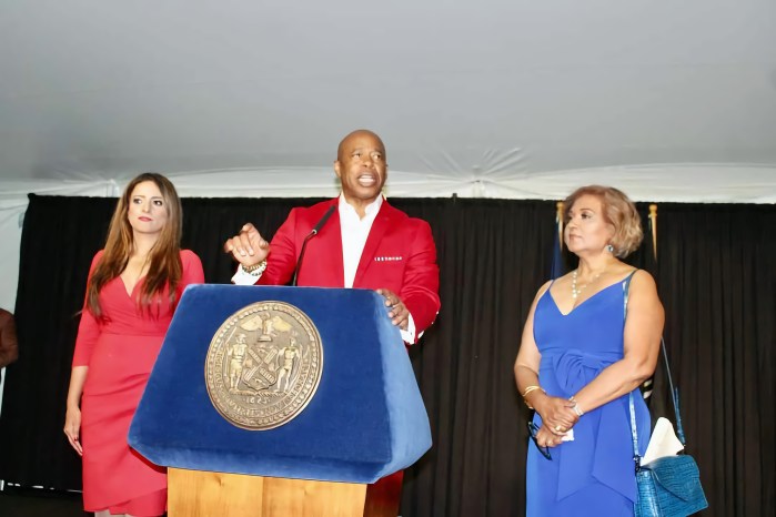 Jennifer Rajkumar, Assemblymember, Mayor Eric L. Adams, and Hazra Ali, at the podium at a June 27, Caribbean Heritage Month reception at Gracie Mansion.