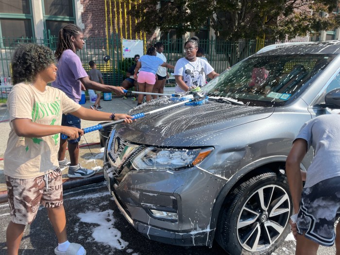 Teamwork makes the dream work! On July 14th, the students turned the block in front of FDA into a car wash and raised $1,011 for our travel fund. From left, Kezia, Tristan, and Kelly.