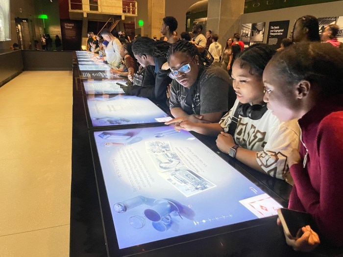 From left, Tristan, Kelly, Kezia, and Nikita learn about the heroic actions of civil rights leaders at the National Museum of African American History and Culture in Washington, D.C.