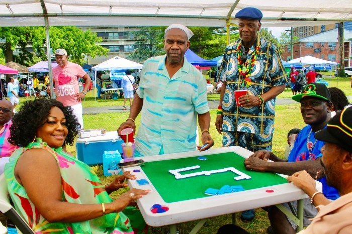 Doris Rodney, left, owner of the Hills Restaurant in Brooklyn, took picnickers by bus to Monte Irving Park, Orange, NJ on July 14, for the Annual Family Fun Day organized by GAHF where they engaged in a game of Dominos.