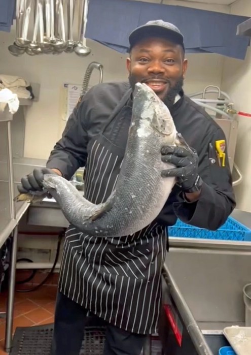 Chef Paul proudly displays a big catch that he is about to cook.