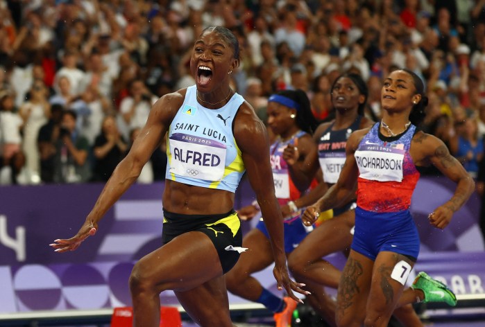 Julien Alfred of Saint Lucia celebrates after crossing the finish line to win gold ahead of Sha'carri Richardson of United States 