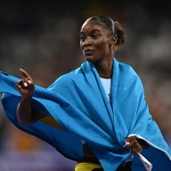 Women's 100m Final - Stade de France, Saint-Denis, France - August 03, 2024. Julien Alfred of Saint Lucia celebrates after winning gold.