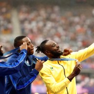 Gold medallist Grant Holloway of United States celebrates on the podium with silver medallist Daniel Roberts of United States and bronze medallist Rasheed Broadbell of Jamaica REUTERS/Alina Smutko