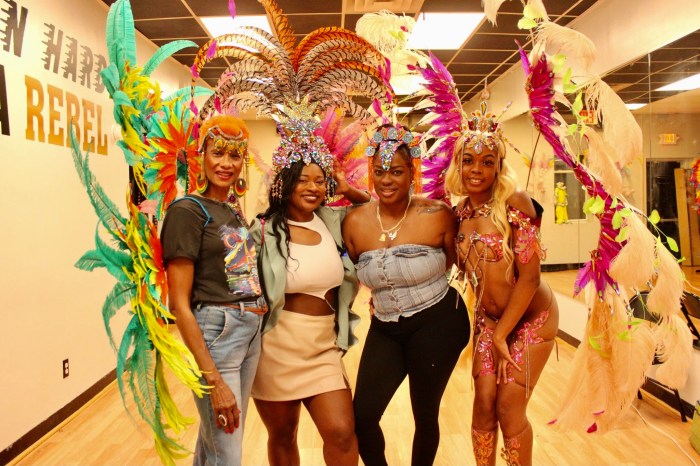 Guests are decked out in costumes head pieces, and wings, designed by Suga Candy Mas on display at the 1196 Nostrand Avenue, Brooklyn Mas camp. Band Leader Maxine Magdaleno, third from left, is next to model Lala Rosayy, ready to masquerade on Labor Day Monday, Sept. 2.
