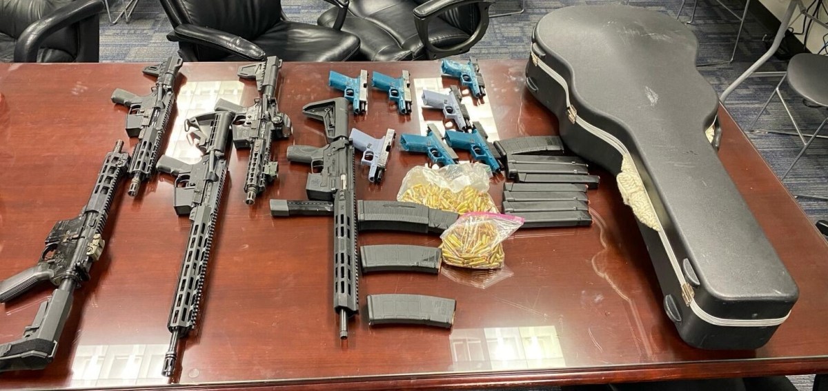 Ghost guns, assault rifles, high-capacity magazines, ammunition, and a guitar case where guns were hidden recovered from an Elmhurst garage defendants used to store weapons