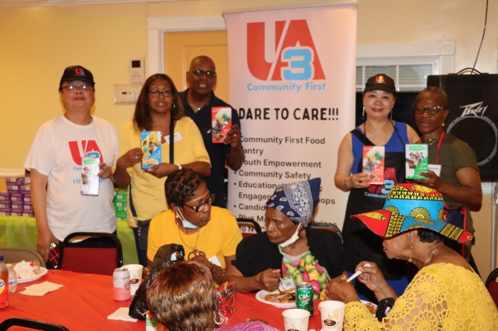 Simon Chick, left, Shally Wong, second from right standing, with Pastor Roger Jackson, First Lady Kim Jackson and Marlene Ferguson (right, standing)