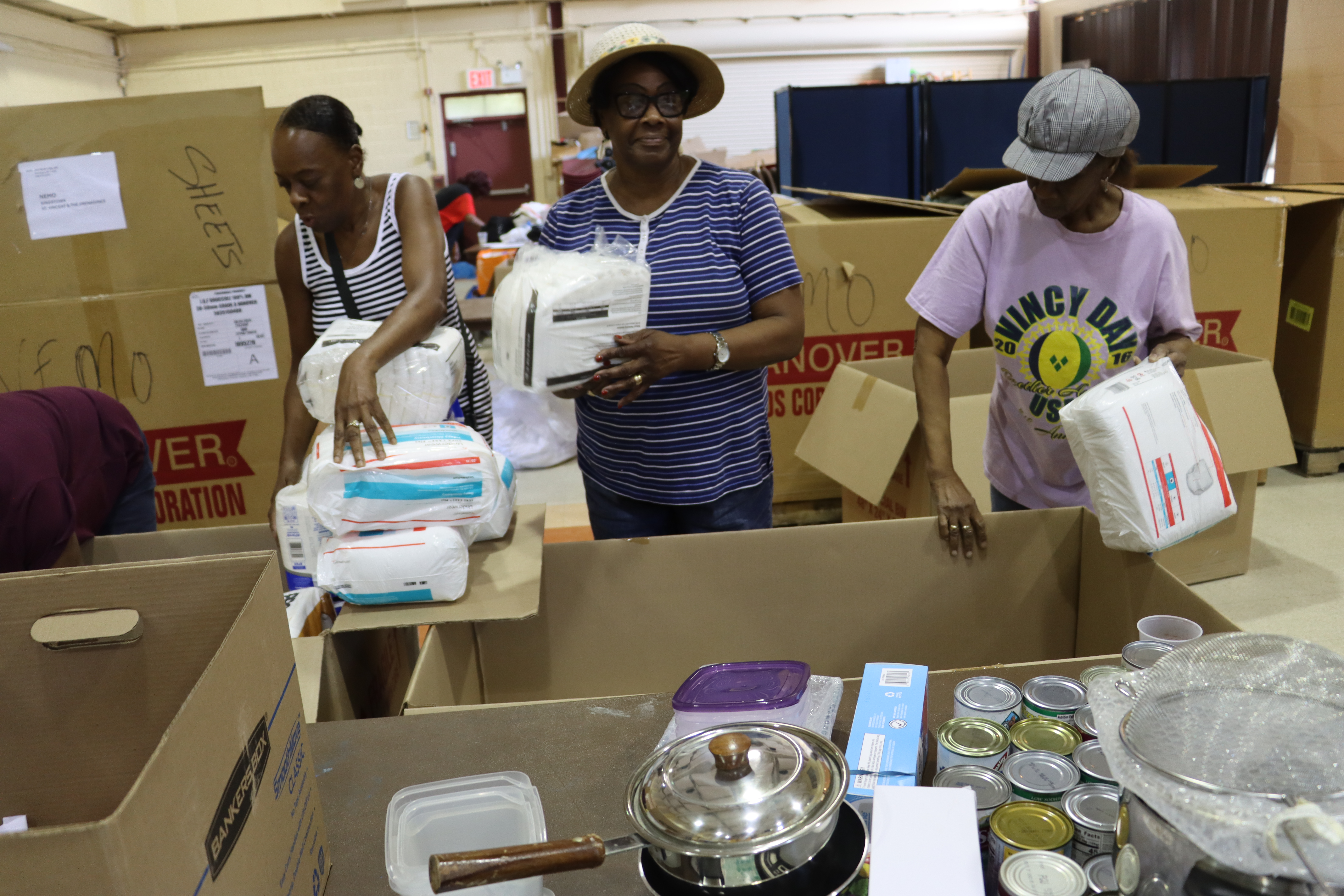 Preparing relief supplies to be shipped to St. Vincent and the Grenadines, L-R: Pamela Mornix, Ancilla Friday and Sandra Millington