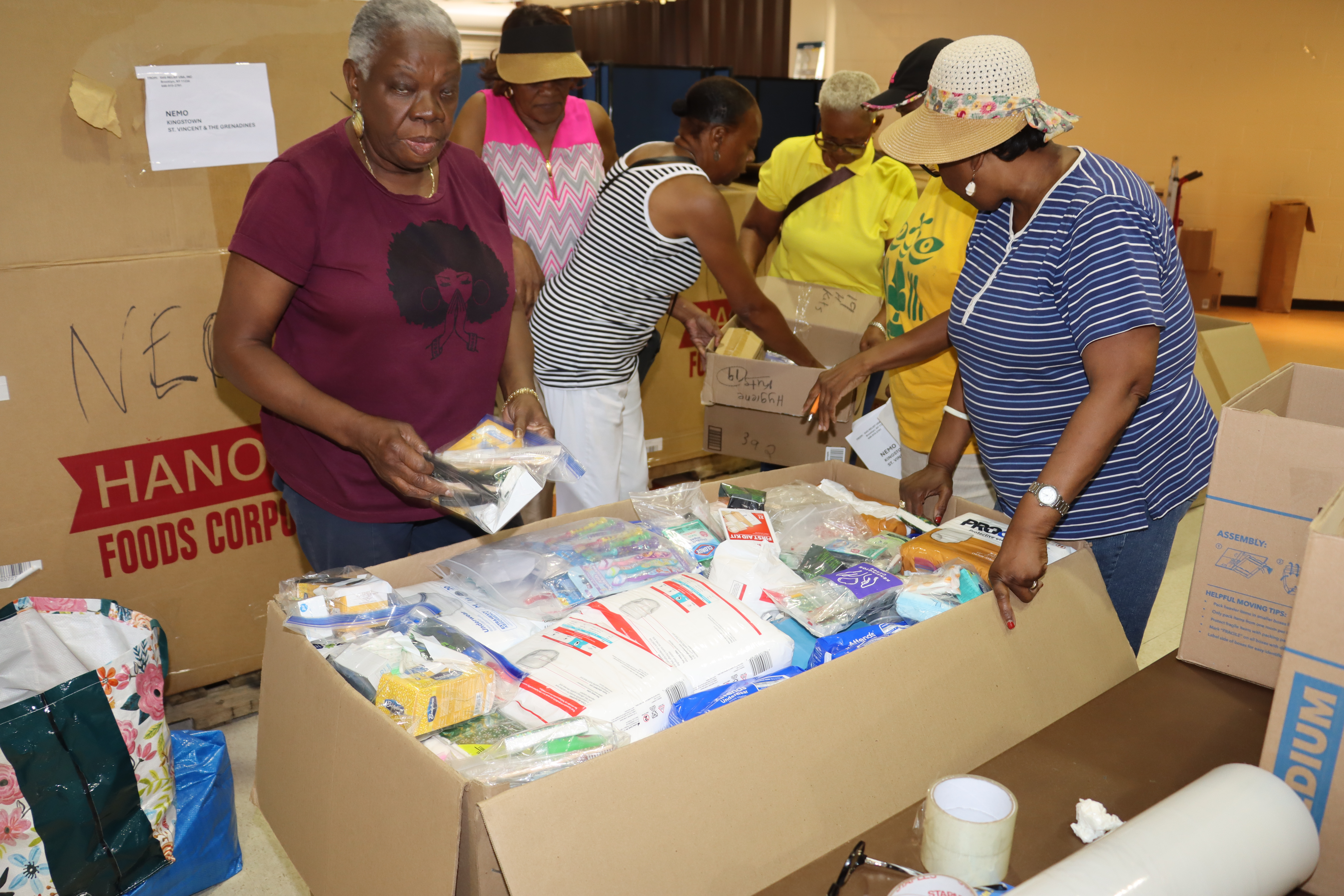 Celia Bramble, left, with Relief Committee members packing supplies, at the Friends of Crown Heights Educational Center in Brooklyn, to be shipped to St. Vincent and the Grenadines