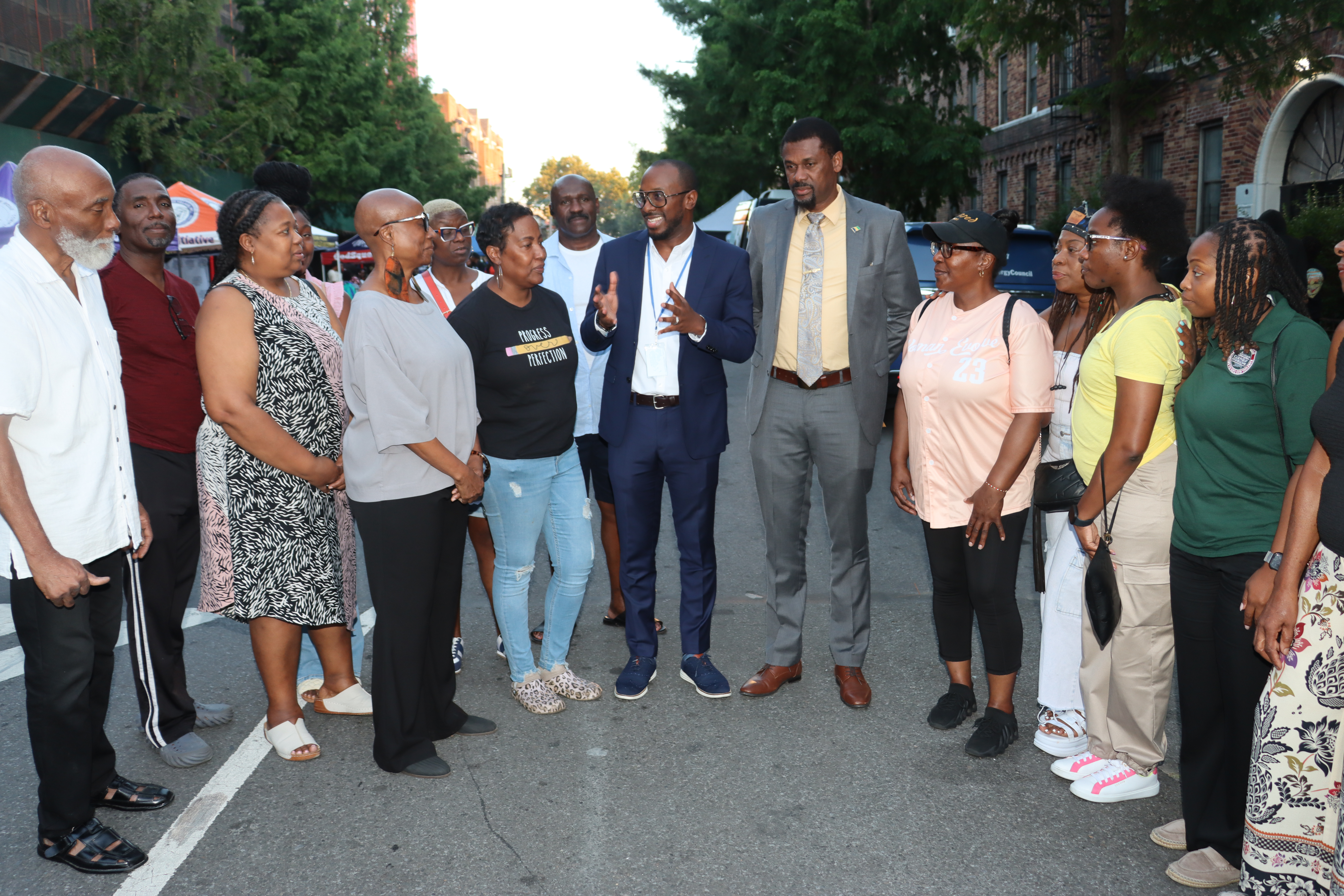 Pastor Louis H. Straker, Jr. , center, addresses ceremony, flanked by SVG Consul General Rondy "Luta" McIntosh, to his left, parishioners and members of the SVG Relief Committee, Inc.