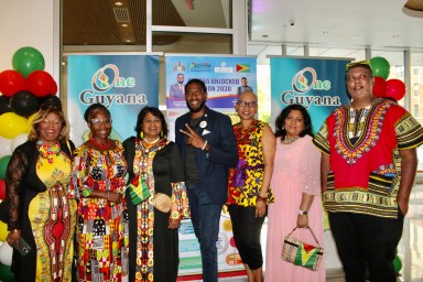 A colorfully dressed group of Guyanese from left Sherry Williams, Claire Patterson Monah, Jenny Persaud, Public Advocate Jumaane Williams, Lourdeth Ferguson, Ramola Persaud, and Leon Jameson Suseran, in the foyer of Medgar Evers College, at an Emancipation Observance hosted by the diplomat office on July 31, at Medgar Evers College.