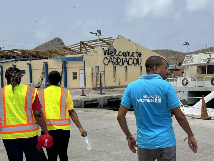 A member of the UN Women’s deployment team is seen walking past a damaged building on Grenada’s sister island of Carriacou.